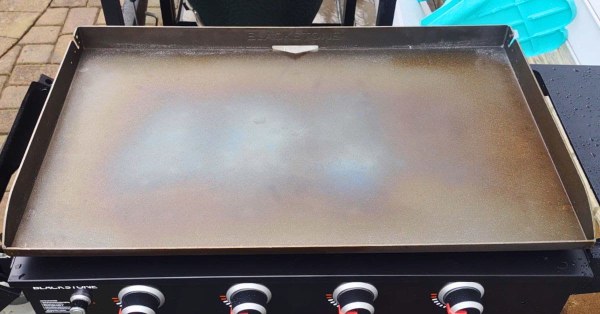 a blackstone griddle on high getting darker for seasoning.