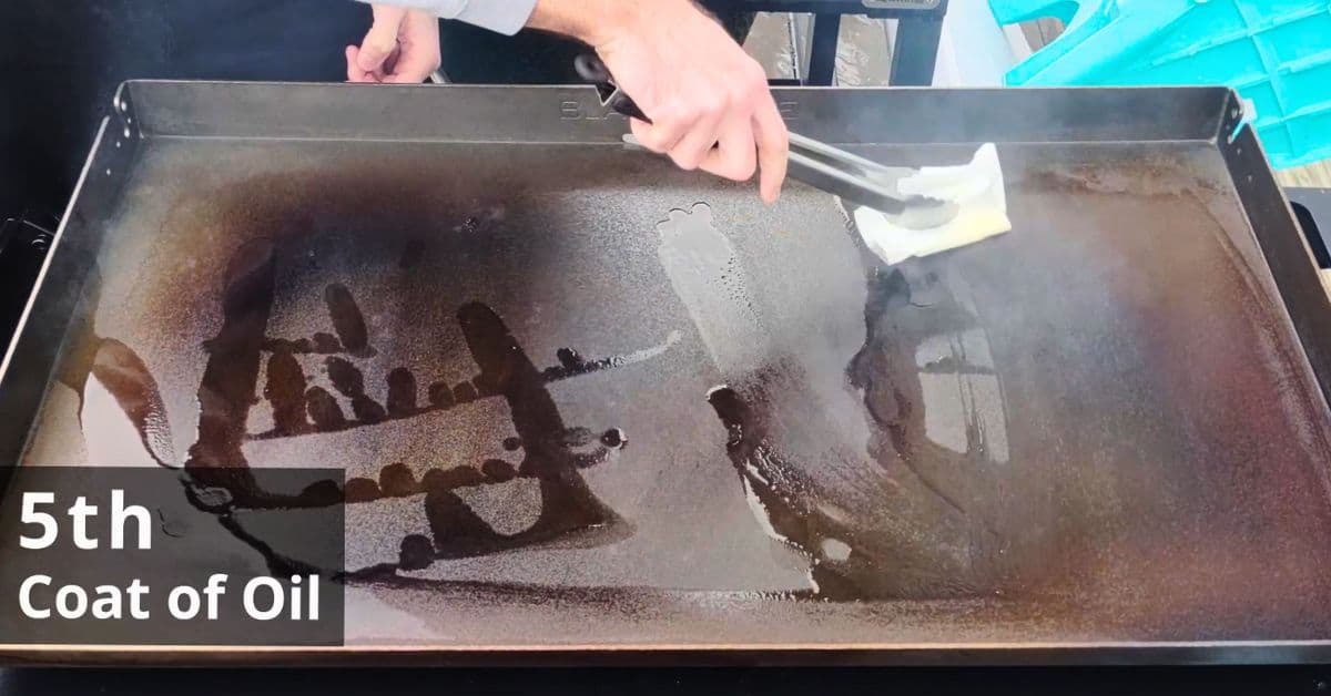 oil being pushed around a hot blackstone griddle for the 5th coat of seasoning.