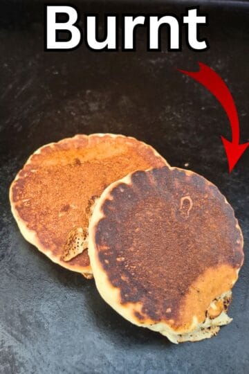 Burnt pancakes on a blackstone griddle with the text "burnt" and a red arrow.
