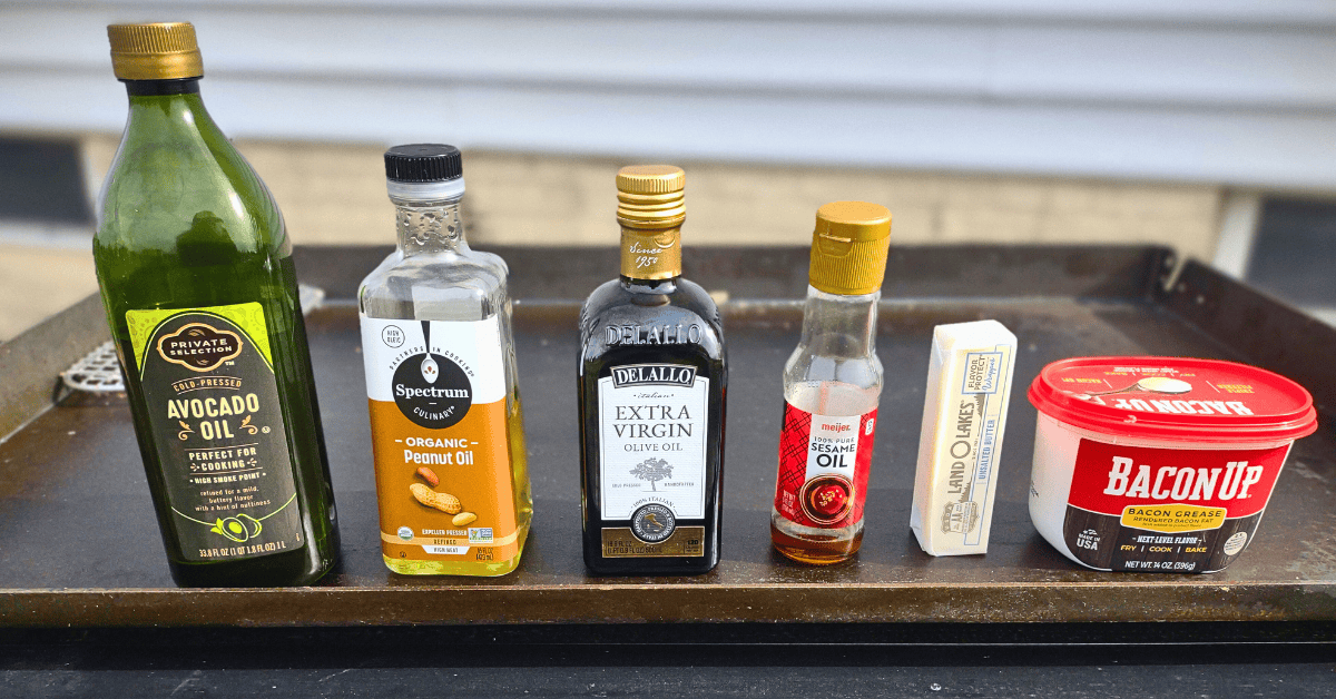 A bunch of different oils on a blackstone griddle