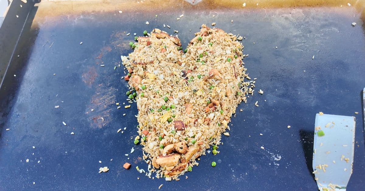 chicken fried rice in the shape of a heart on a blackstone griddle.