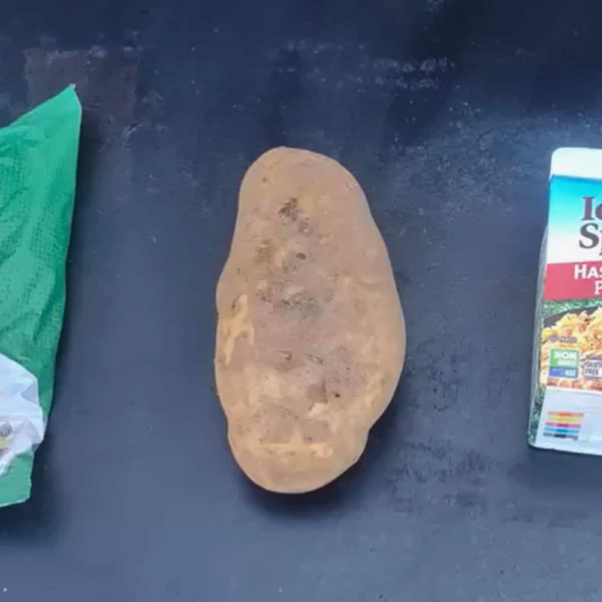 a brown russet potato on a blackstone griddle
