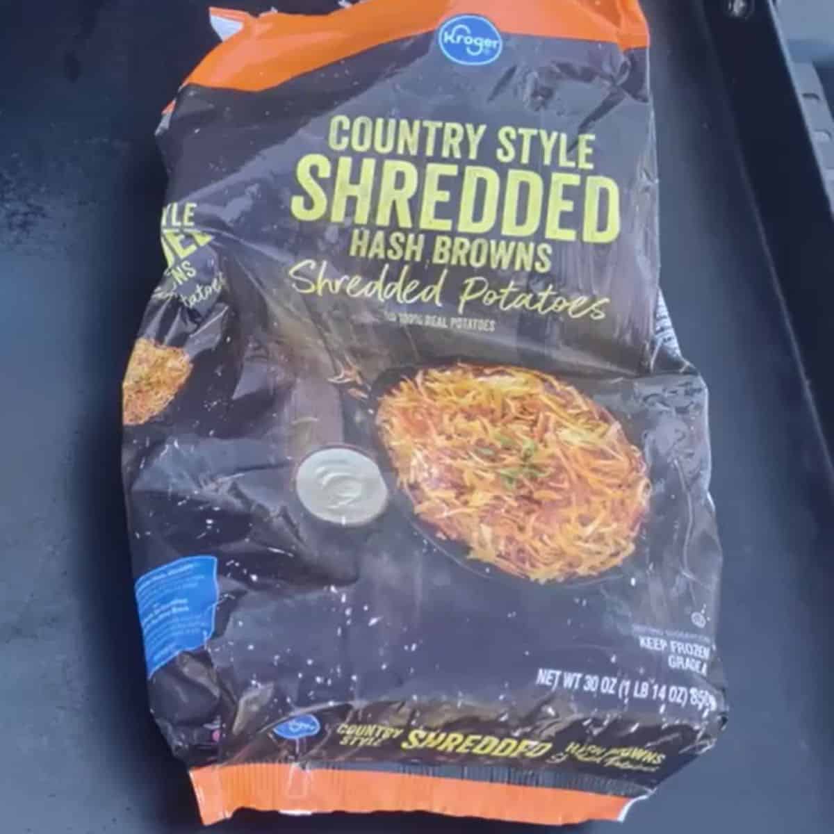 a bag of frozen shredded hash browns on a blackstone griddle