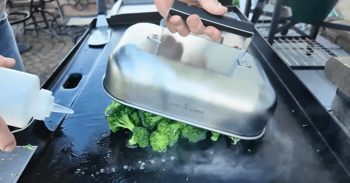 a rectangular dome on a blackstone griddle with broccoli.
