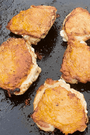 Cripsy golden brown chicken thighs on a Blackstone griddle
